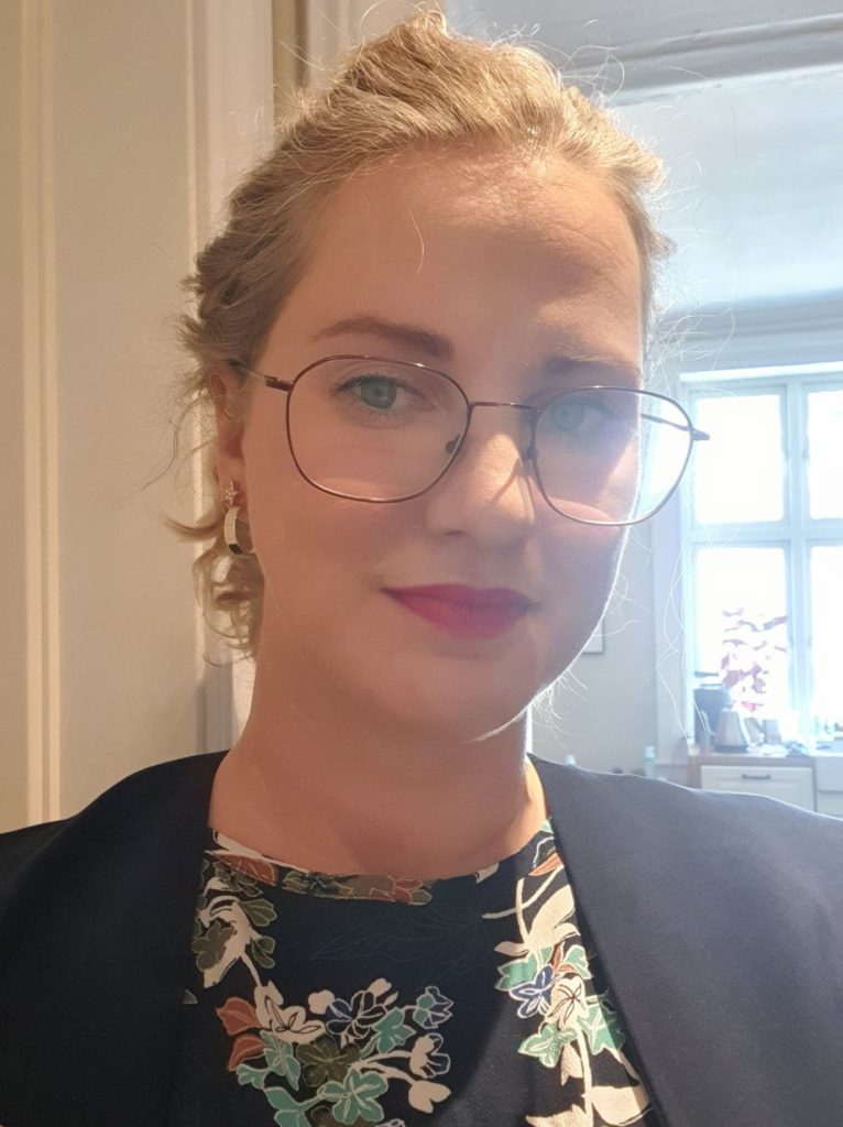 Portrettbilde av Malin Daviknes i Redd Barna. Har på seg mønstrete bluse og sort jakke. 